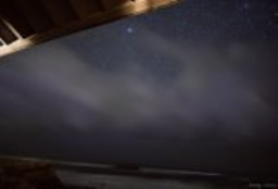 The Pleiades above a storm